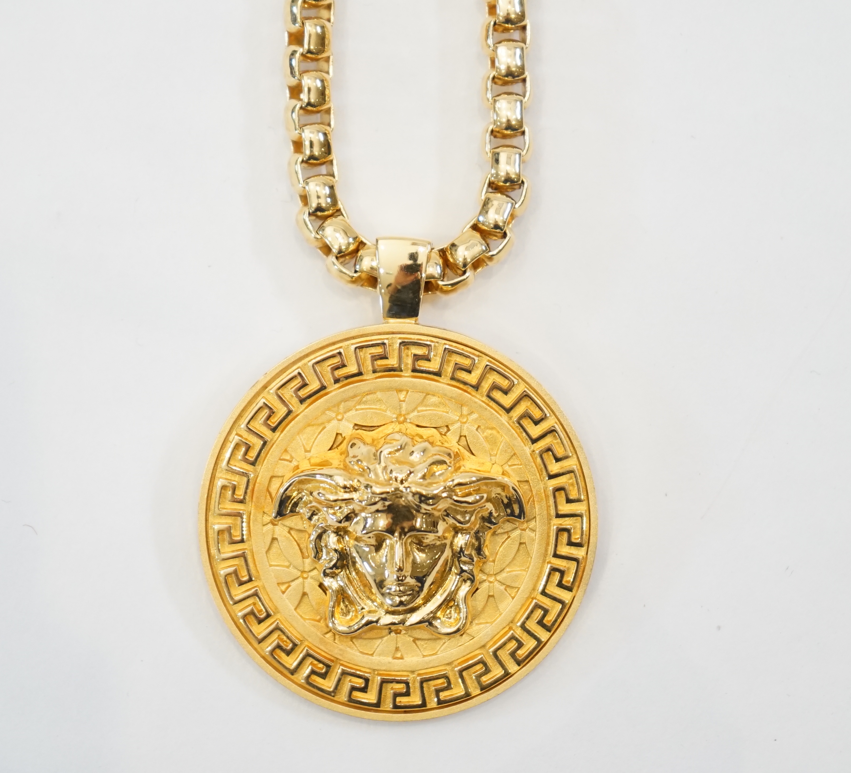 A Versace Medusa gold Greca medallion coin pendant with chunky rapper necklace, chain full length 64cm, medallion 5cm across